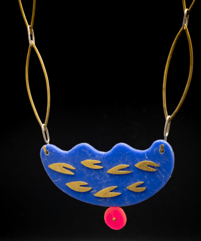 Bold, abstract shape contemporary modern art jewellery necklace pendant blue with brass chain and pink accent. Statement necklace