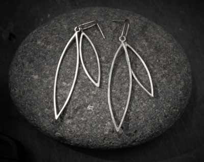 Sleek minimal design leaf shape outline double dangle stud earrings, handmade in recycled silver by Becky Crawford in Devon, UK.