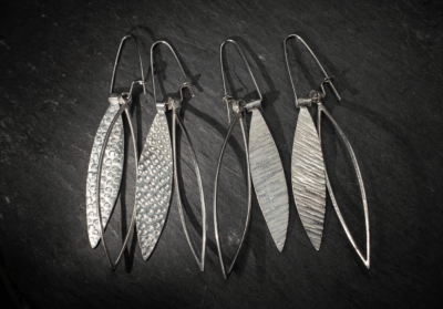 Long dangly silver leaf shape earrings, textured and outline. Dimpled texture handmade from recycled silver in Devon, UK - Image 4